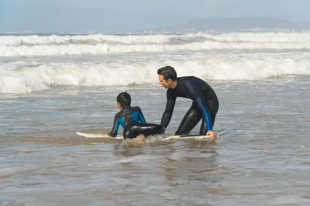 Beginner surf lesson with instructor in shallow waves near Hiriketiya Beach