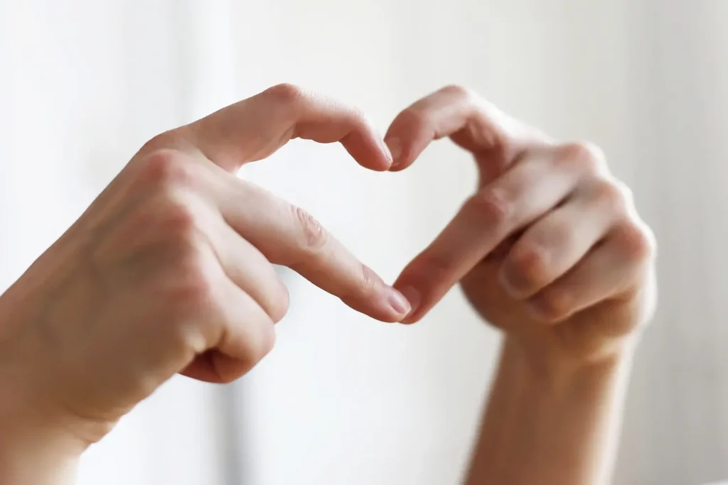 Hands making a heart shape symbolising romance and connection