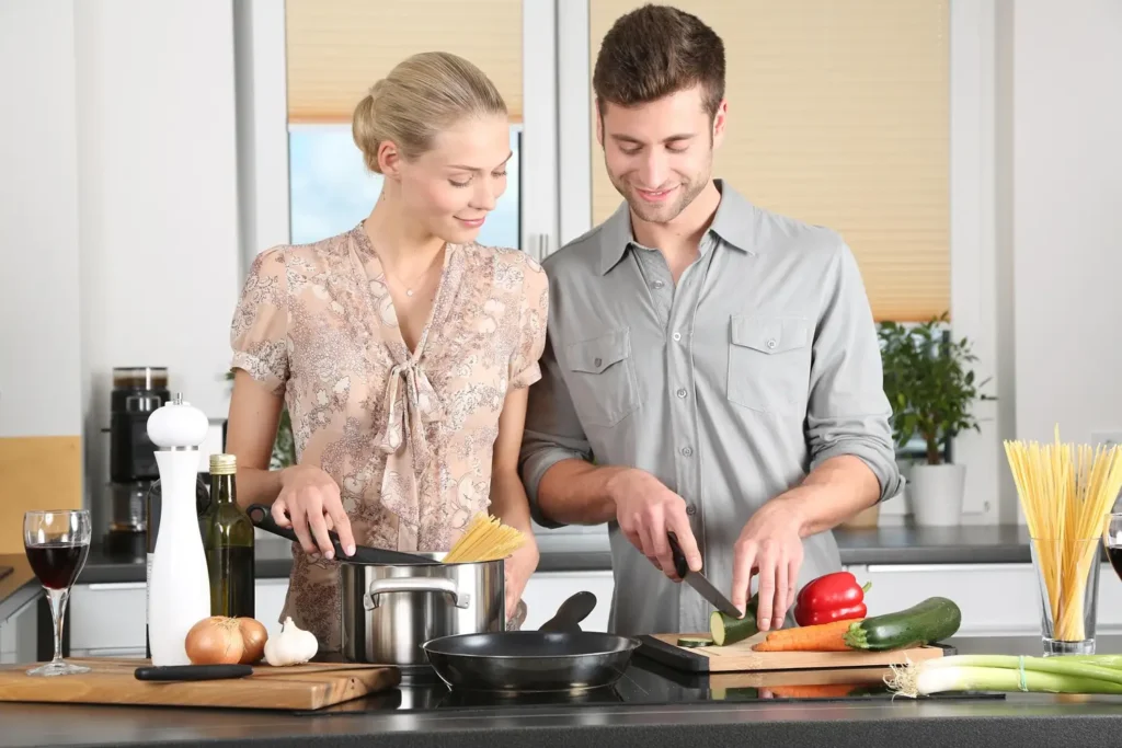 Couple cooking together during a romantic getaway experience