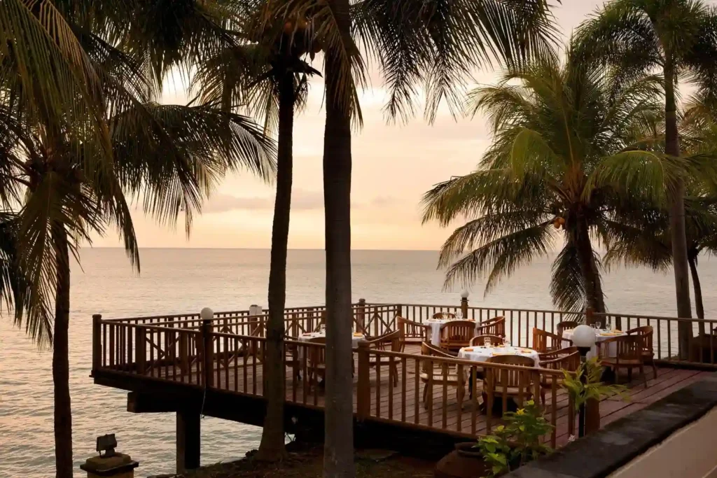 Romantic sea-view restaurant deck surrounded by palm trees at Agonda