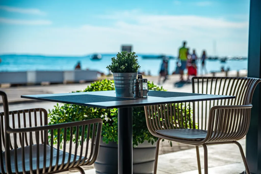  Outdoor cafe seating area near Kite Beach Dubai promenade with sea view
