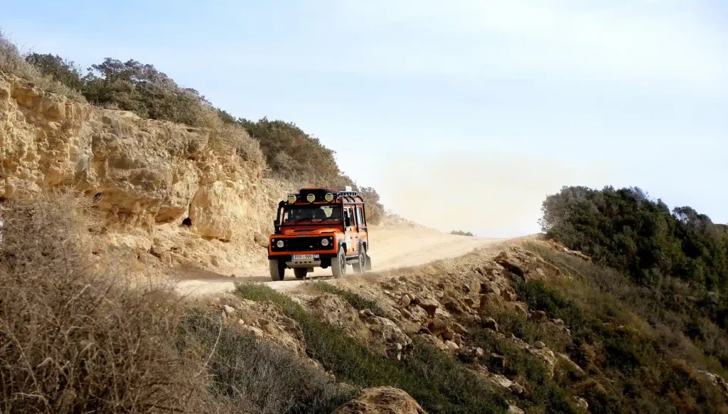 Off-road vehicle driving on a dusty road toward Port Barton Palawan