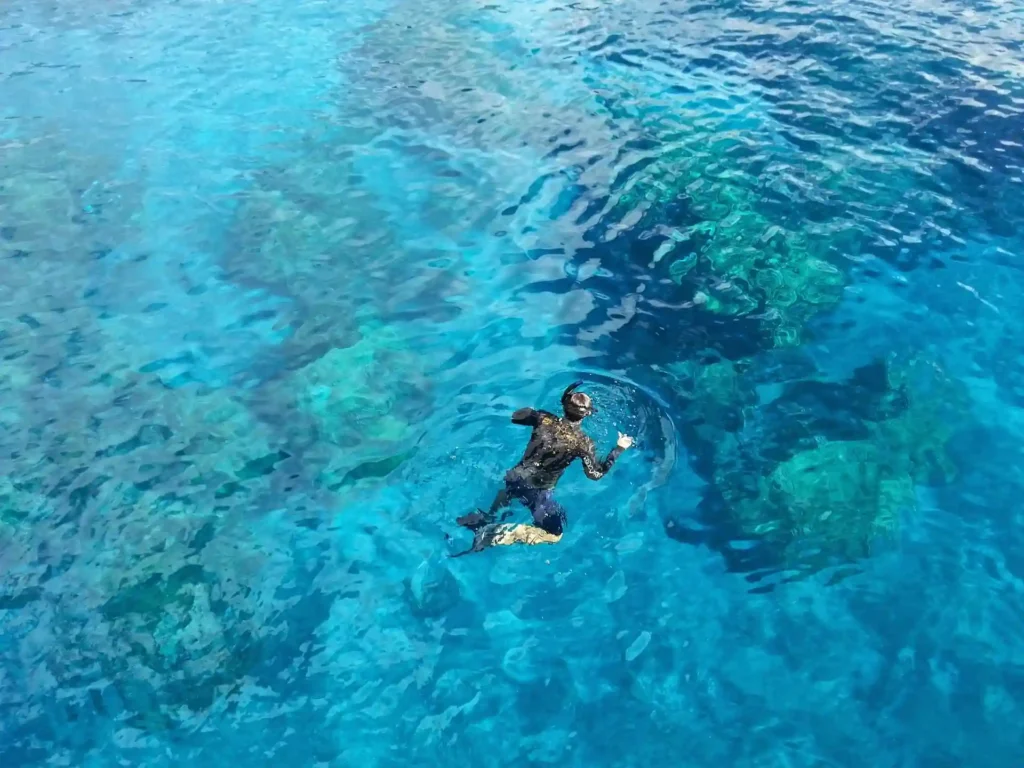 Diver exploring clear waters around Pulau Kapas island