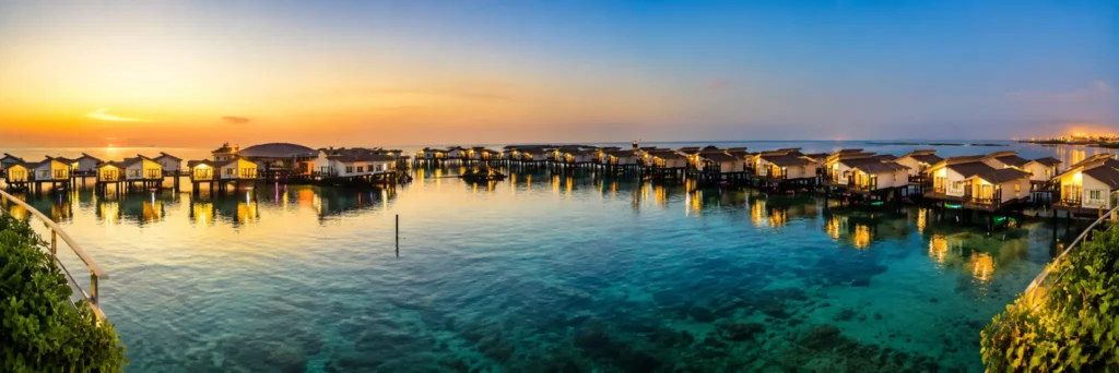 Luxury overwater villas at Toranj Marine Hotel during sunset on Kish Island