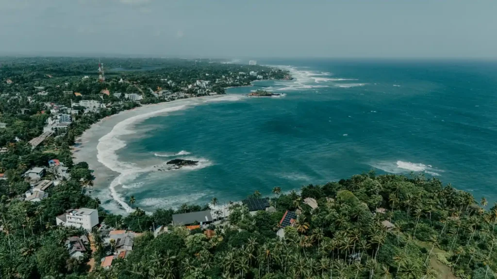 Aerial view of Hiriketiya Bay with turquoise water and tropical coastline in Sri Lanka