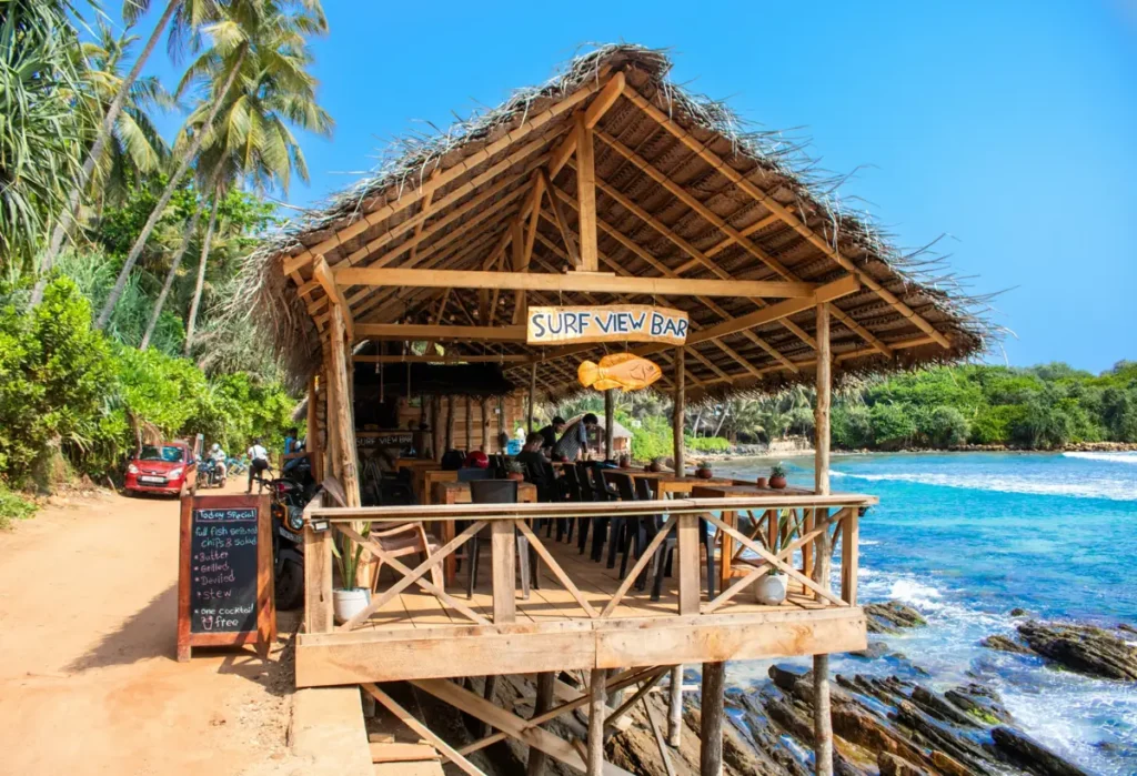 Surf view bar overlooking rocky coastline near Hiriketiya hidden beaches in Sri Lanka