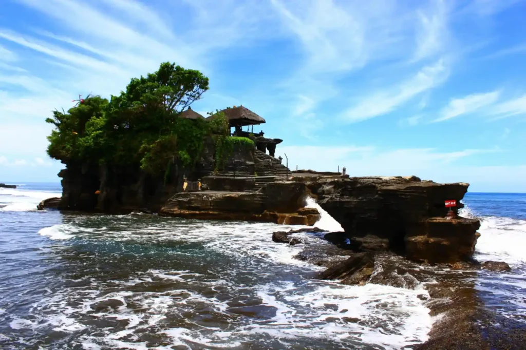 Traditional Balinese sea temple surrounded by ocean waves
