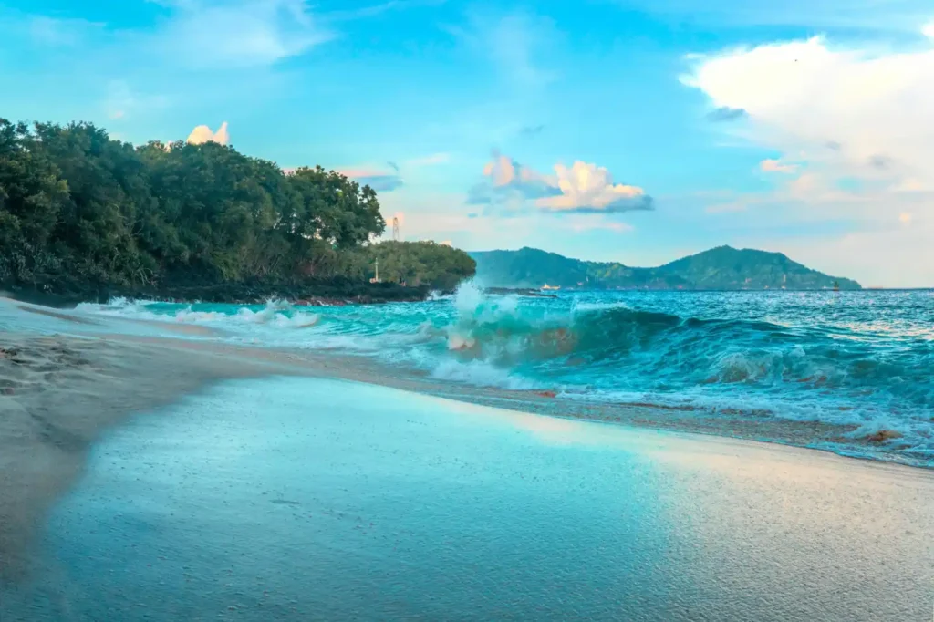 Wide-angle shoreline reflection at Nyang Nyang Beach during sunset
