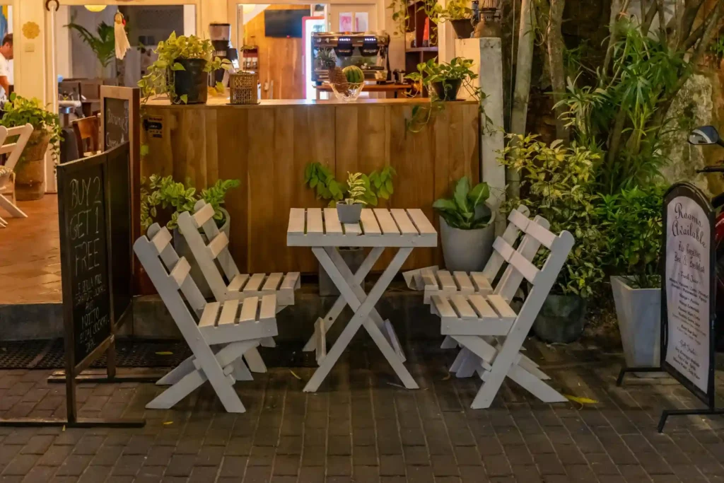 Cozy Sri Lanka beach café with plants and wooden seating at night