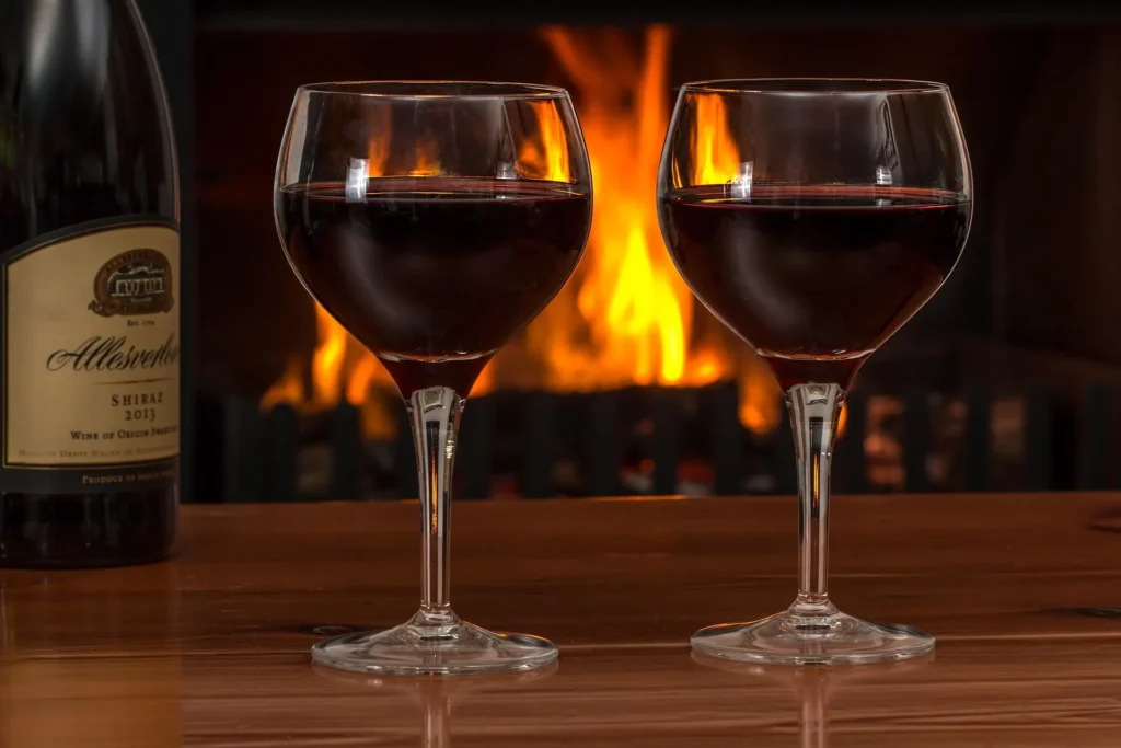 Red wine glasses and drinks served during a cozy beach evening in Agonda.