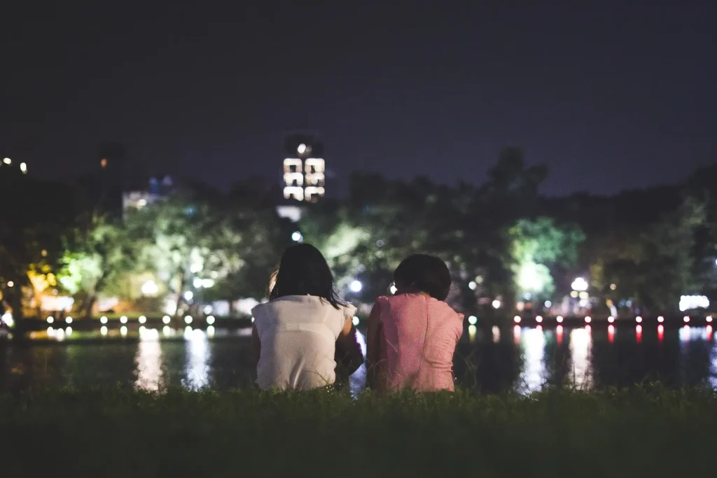 Couple enjoying peaceful night views near Agonda Beach waterfront.