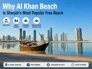 Traditional wooden dhow boat resting on the shoreline at Al Khan Beach with Sharjah skyline reflections under a clear blue sky.