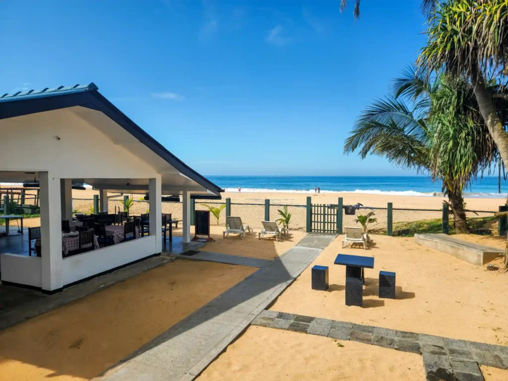 Beachfront cafe in Hiriketiya with ocean view seating and palm trees