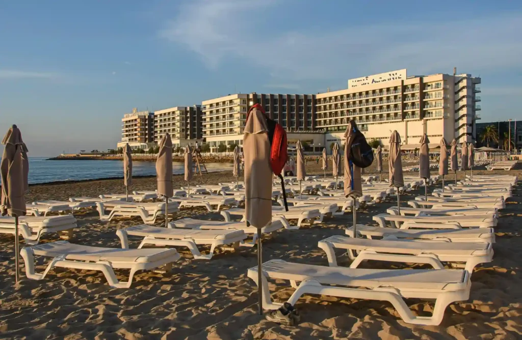 Beach resort area near Gisoom Beach with sun loungers, umbrellas, and seaside hotel view along the Caspian coast in Iran