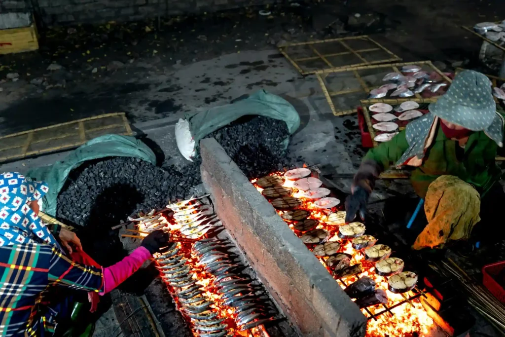 Fresh fish grilled over open fire at a Sri Lankan beach market