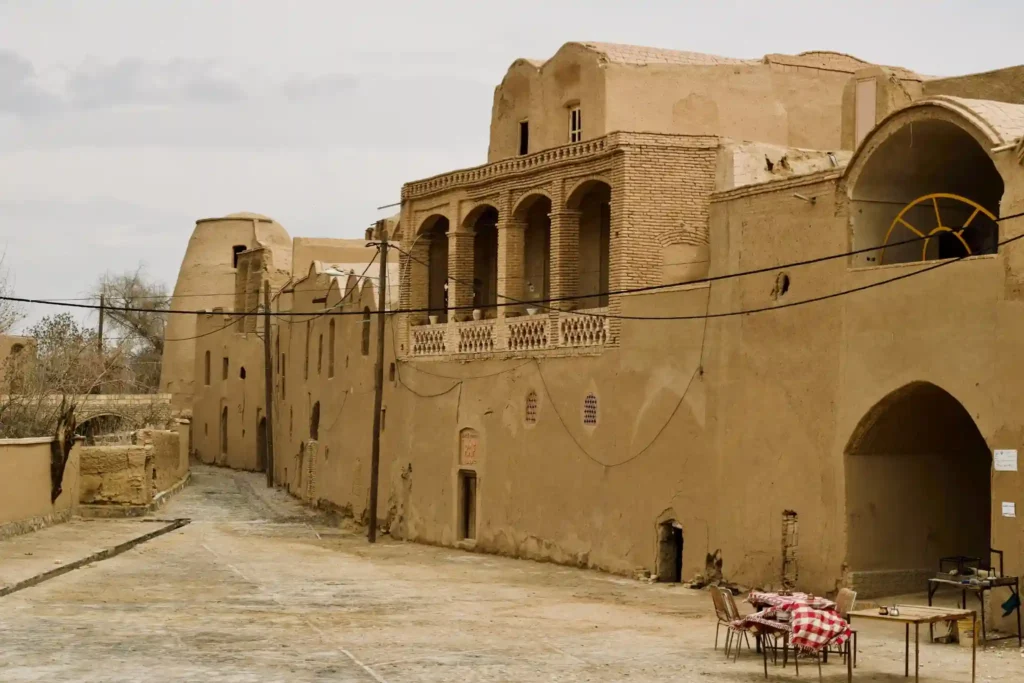 Traditional mud-brick houses and ancient desert architecture in a historic Iranian village with narrow streets and arched buildings