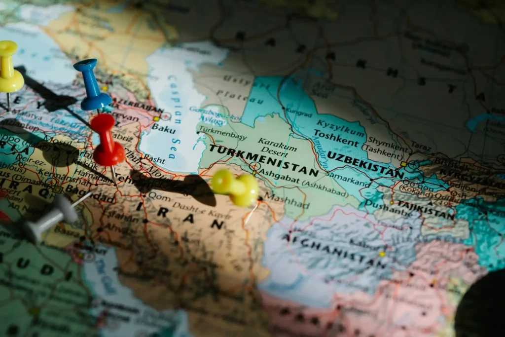 Close-up map of Iran and surrounding Middle Eastern countries with colorful location pins marking travel destinations and routes