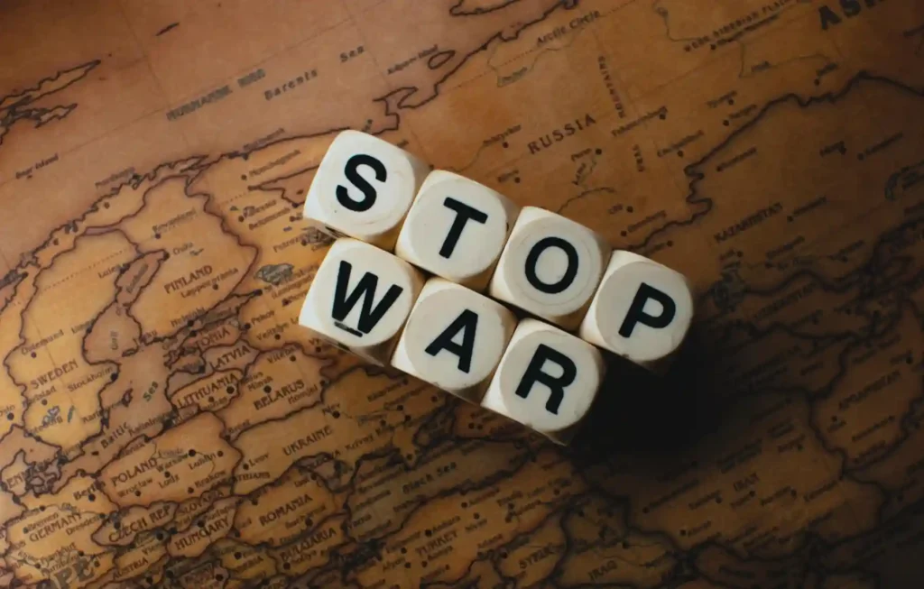 Stop war text blocks placed on a vintage world map representing travel safety concerns and geopolitical tensions related to Iran tourism