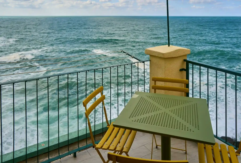 oceanfront balcony with chairs overlooking sea waves