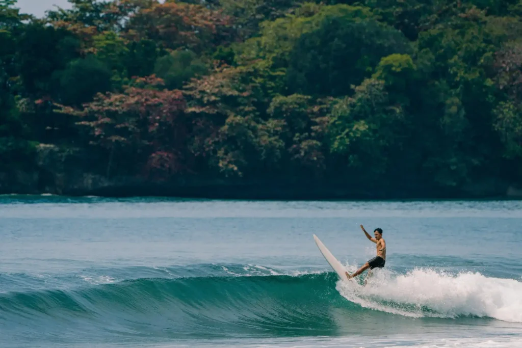 Surfer riding powerful waves at Padang Padang Beach