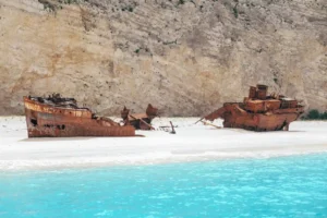 Rusted abandoned shipwreck on Nyang Nyang Beach shoreline in Bali
