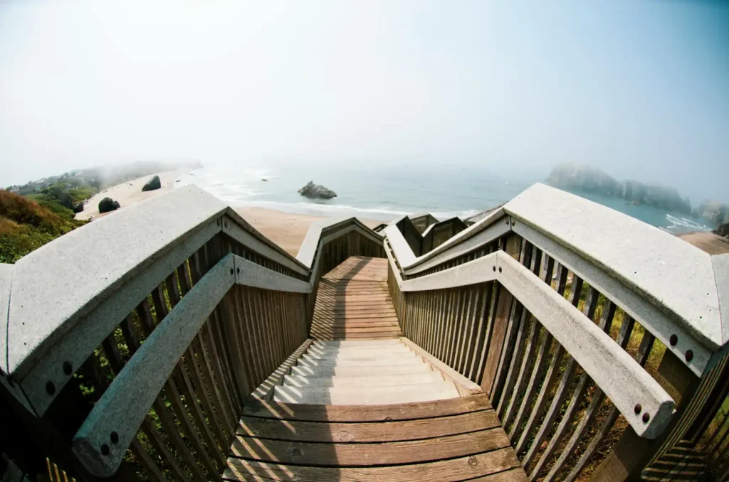 Steep staircase trail leading down to a hidden beach
