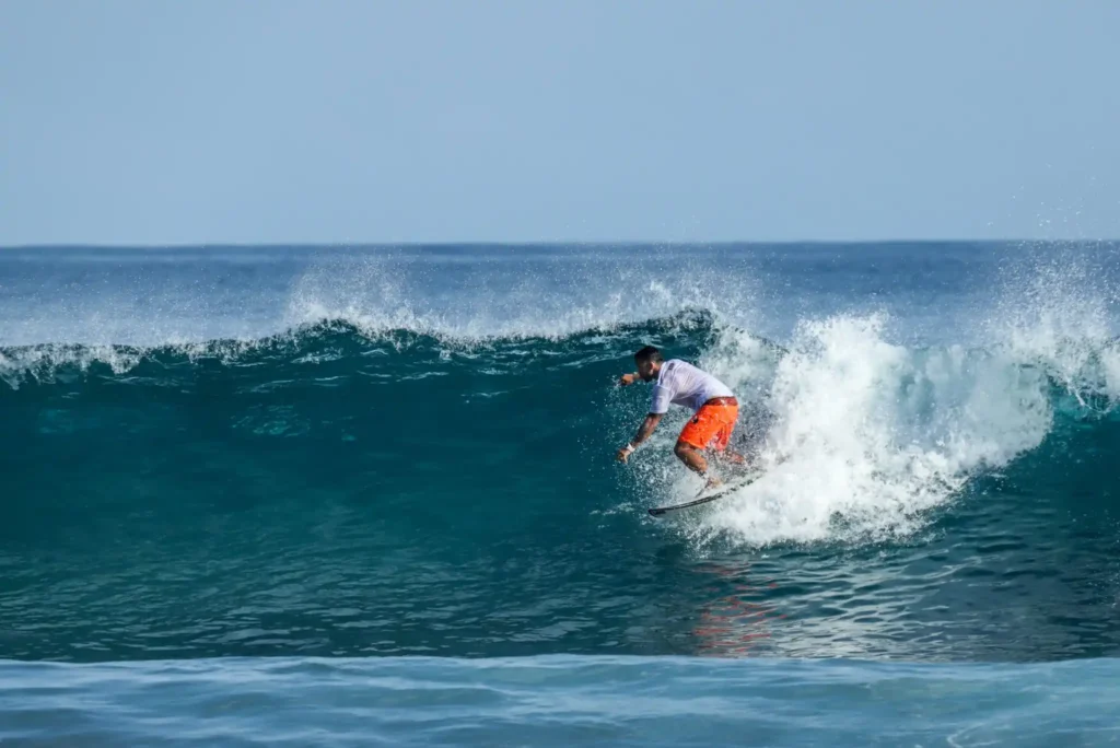 Surfer riding a powerful ocean wave.