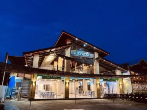 Backpackers Port Barton hostel exterior illuminated at night with modern facilities in Port Barton, Palawan.