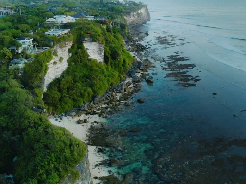 Aerial view of Balangan Beach cliffs and turquoise coastline in Bali, Indonesia.