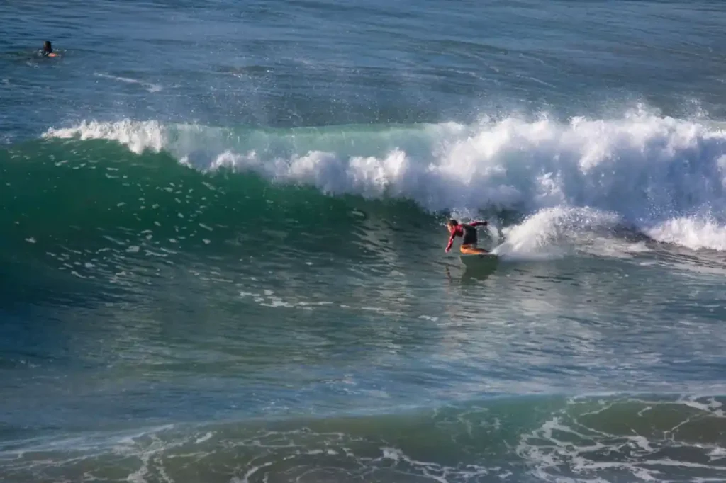 Surfer riding a wave at Balangan Beach.