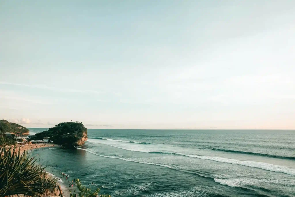 Ocean waves rolling onto Balangan Beach at sunset in Bali.