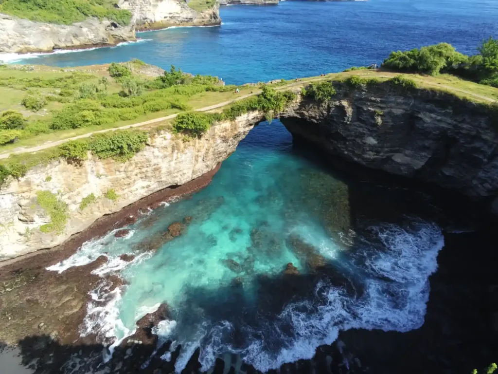 Aerial view of Broken Beach sea arch and turquoise waters in Nusa Penida.
