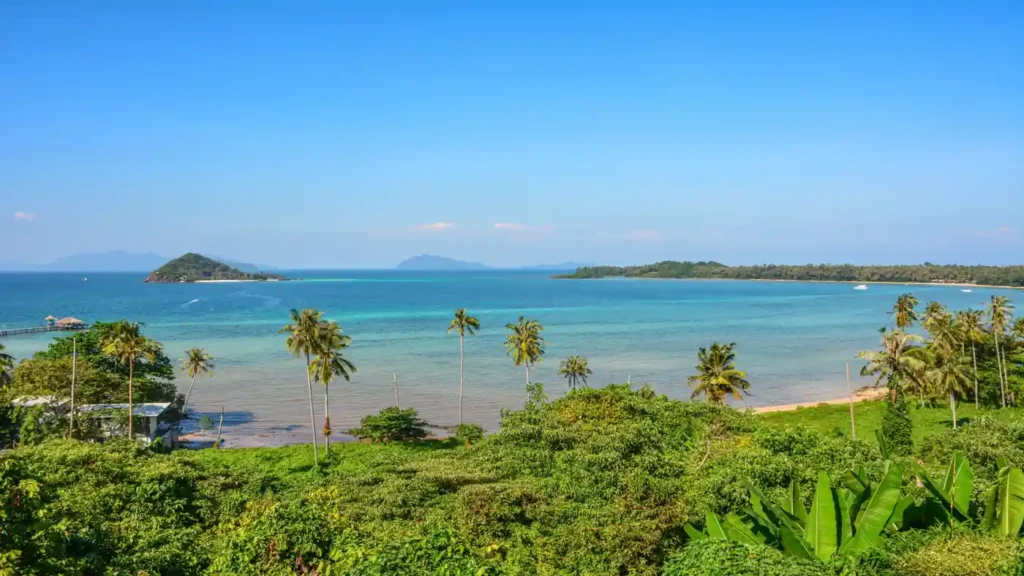 Panoramic Koh Chang coastline with tropical islands and palm trees.