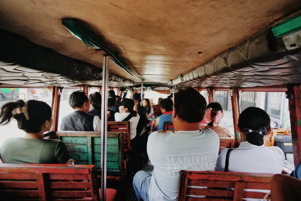 Passengers travelling inside a local public bus, showing an affordable transport option for reaching Anda Beach in Bohol.