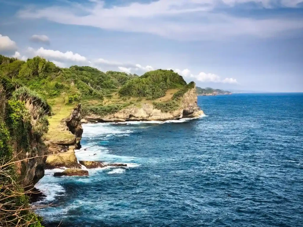 Rocky coastal cliffs and blue ocean in Nusa Penida.