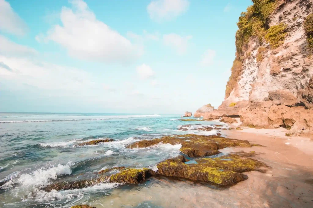 Dreamland beach with coastal cliffs and gentle ocean waves.