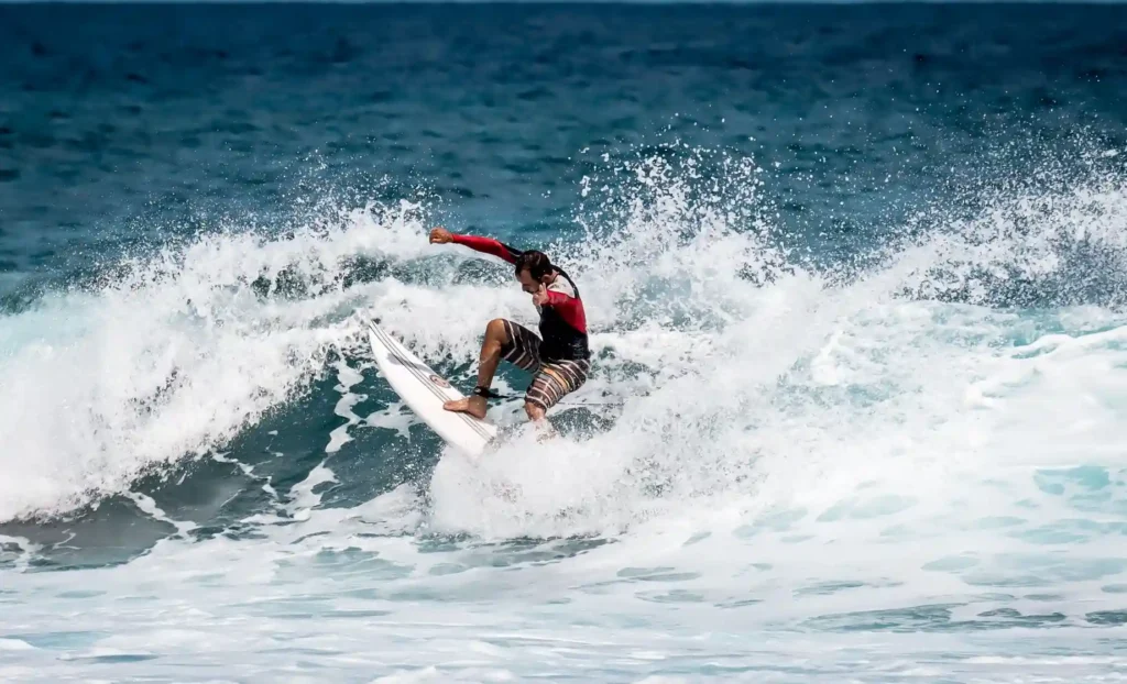 Surfer carving through a breaking ocean wave.