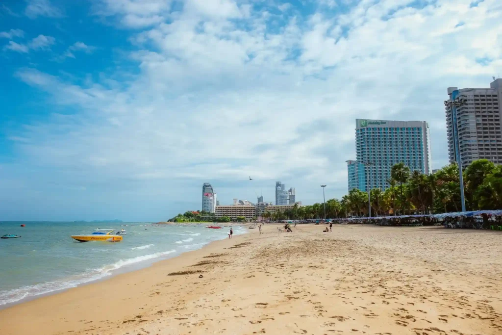 White sand beach with beachfront hotels and calm sea.