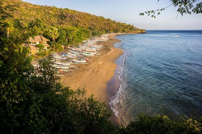 Amed Beach coastline with traditional fishing boats.