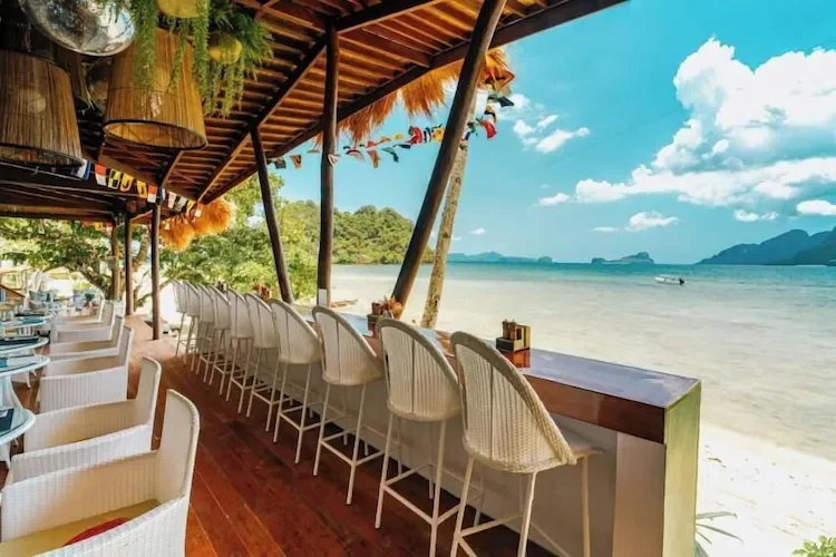 Beachfront dining area at El Nido Beach Huts overlooking the sea.