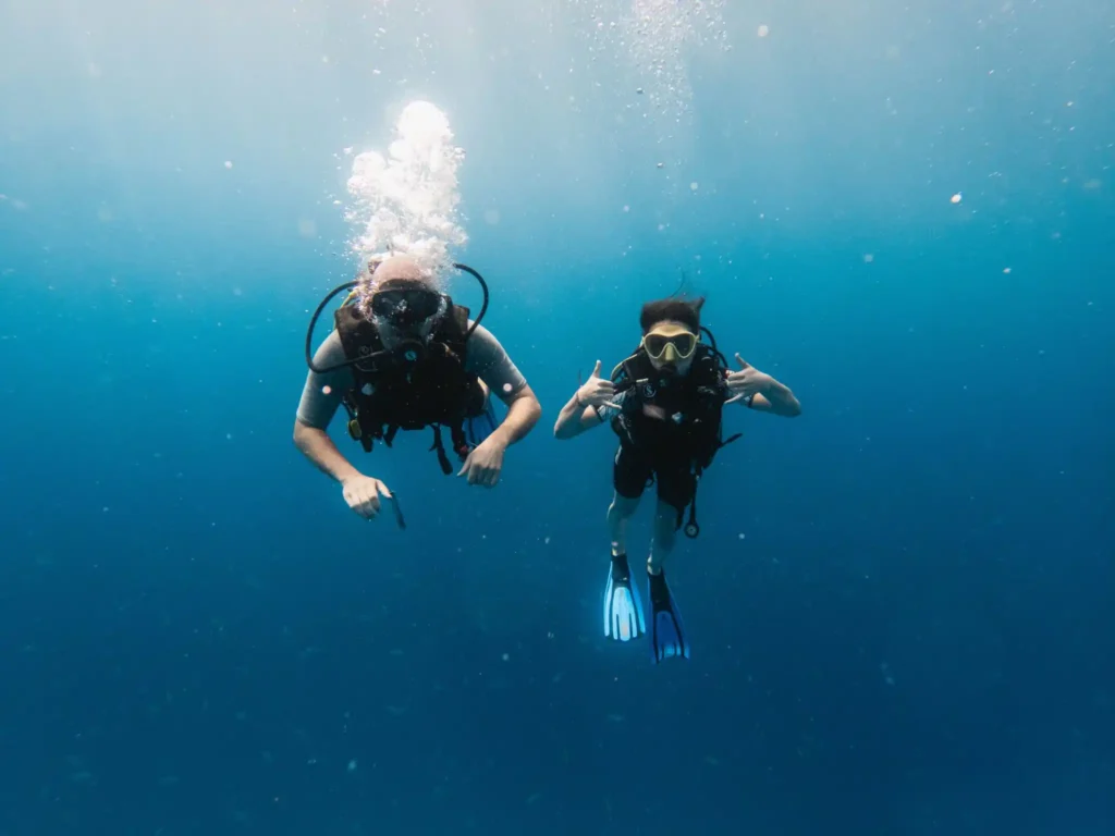 Scuba divers exploring the clear waters of Koh Chang. 