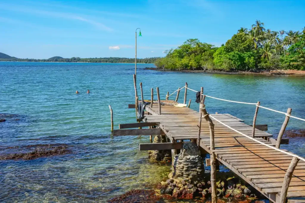 Wooden pier extending into the clear turquoise waters of Koh Kood.