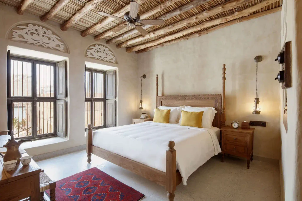 Al Seef Hotel Dubai traditional bedroom with wooden four poster bed and rustic decor
